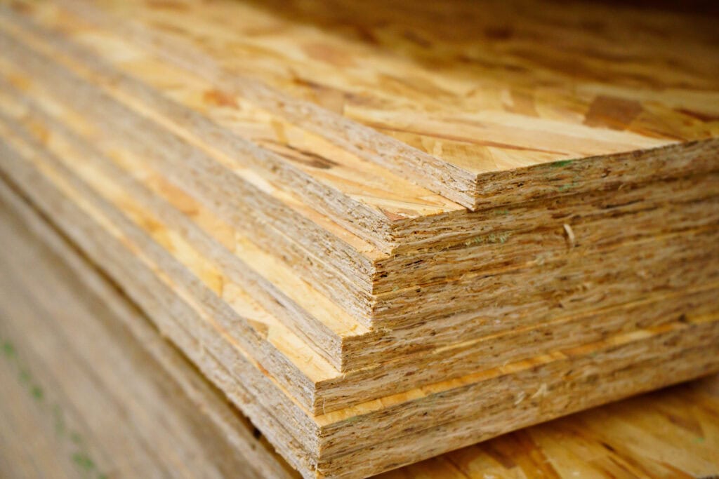 Stacked OSB boards manufactured with precision cutting equipment utilizing Zenith Cutter industrial knives.