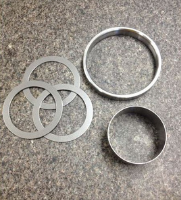 Close-up image of metal fabricated rings and washers, manufactured by SC Industries in Houston.