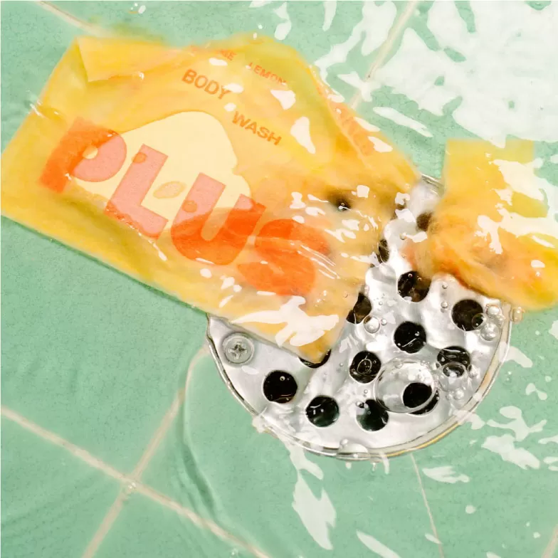 water dissolving label of plus body wash soap going down the drain